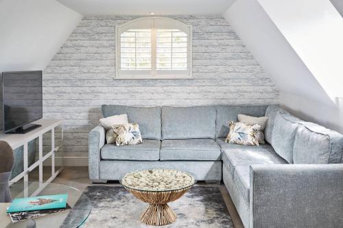 a living room with a couch and a table at Barnett Hill Hotel in Guildford