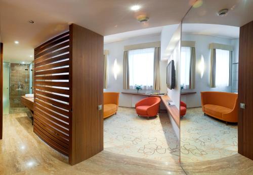 a lobby with a waiting room with orange furniture at Grund Resort Golf and Ski in Mladé Buky