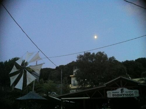two kites are flying in the sky with the moon at Dionysus House Lasithi Plateau in Magoulás