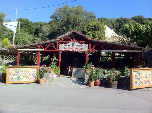 a flower shop with potted plants in front of it at Dionysus House Lasithi Plateau in Magoulás