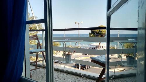 a view of the ocean from a room with a window at Starfish Seaside Studio in Artemida