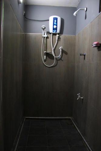 a bathroom with a shower with a soap dispenser on the wall at Sigiriya Lahiru Homestay in Sigiriya