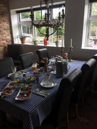 a table with a blue and white checked table cloth at Molino in Bønnerup Strand