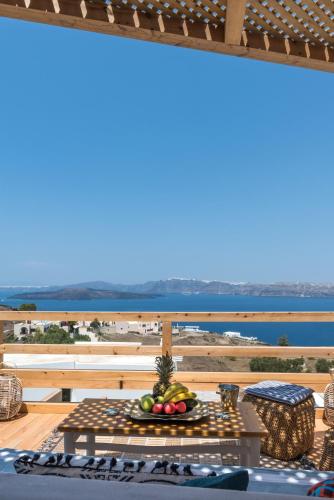 a table with a bowl of fruit on top of a balcony at Summer Lovers Villa in Akrotiri