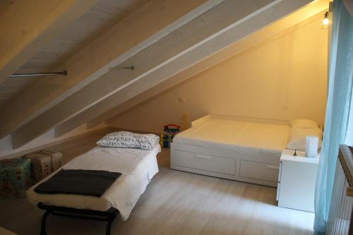 a bedroom with two beds in a attic at Il Piccolo Loft della Vela in Savona