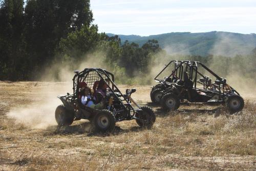 two people riding in quad bikes in a field at Hotel Da Montanha in Pedrógão Pequeno