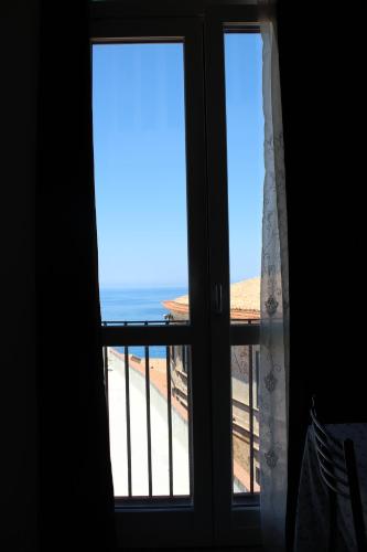 an open window with a view of the beach at Angels'Home A 'n D in Pizzo