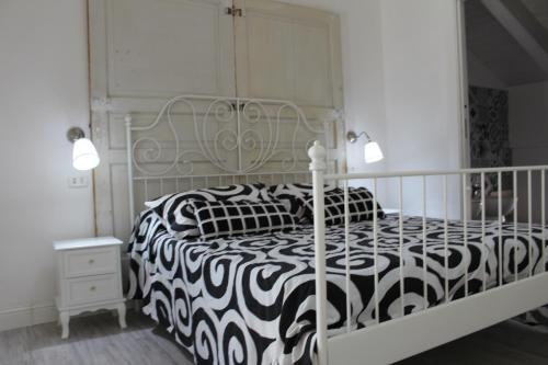 a white bedroom with a black and white bed at Angels'Home A 'n D in Pizzo