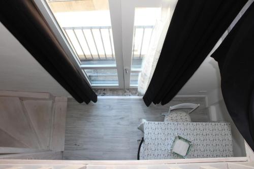 a room with black curtains and a bed and a window at Angels'Home A 'n D in Pizzo