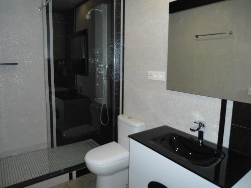 a bathroom with a toilet and a sink and a shower at casa Mariona in Riumar