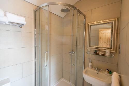 a bathroom with a shower and a sink at Deighton Lodge in York