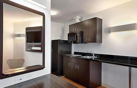 a kitchen with a sink and a mirror at Motel 6-Swift Current, SK in Swift Current