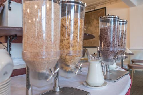 a table topped with two blenders filled with food at Nethybridge Hotel in Nethy Bridge