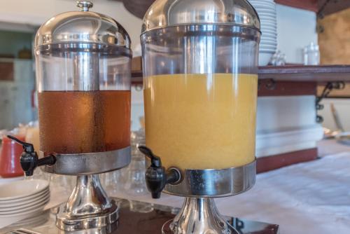 two blenders sitting on top of a counter with juice at Nethybridge Hotel in Nethy Bridge