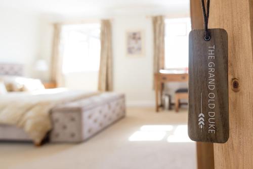 a wooden door tag in a bedroom with a bed at Deighton Lodge in York