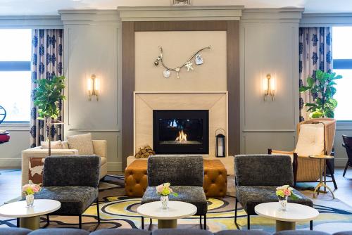 a living room with a fireplace and couches at Delamar West Hartford in West Hartford