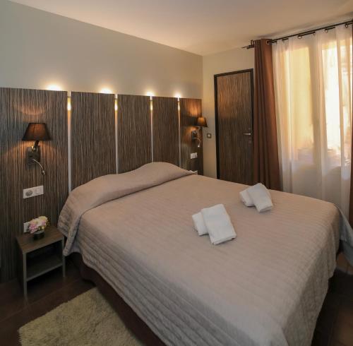 a bedroom with a bed with two white pillows on it at L'Escale in Bonifacio
