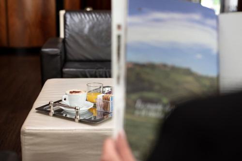 a table with a cup of coffee and a tray of food at Smart Hotel Holiday in Mestre