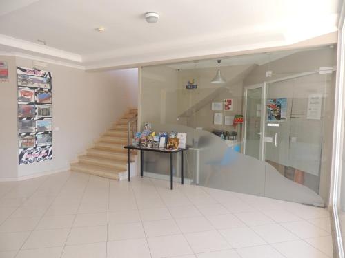 a hallway with a staircase and a table in a building at Kiss - Apartamentos Turísticos in Albufeira