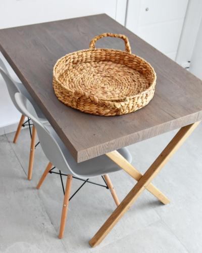 a wicker basket sitting on top of a wooden table at Angelos Boutique Suites in Patitiri