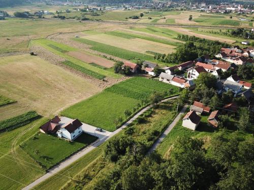 an aerial view of a village with houses and fields at Rooms Ivan in Otočac