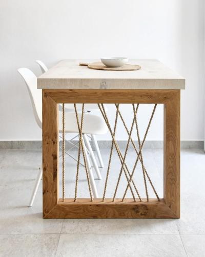 a wooden table with a marble top at Angelos Boutique Suites in Patitiri
