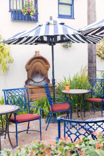 a patio with tables and chairs and an umbrella at Casa Laguna Hotel & Spa in Laguna Beach