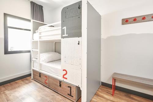 a room with a bunk bed with two question marks on it at Generator Madrid in Madrid