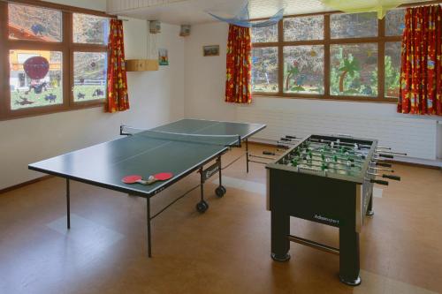a room with two ping pong tables in it at Appartement Flora in Saas-Almagell
