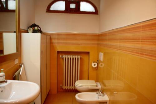 a bathroom with a toilet and a sink at Villa Andrea in Bari