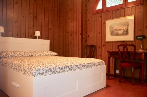 a bedroom with a bed in a room with wooden walls at Villa Andrea in Bari