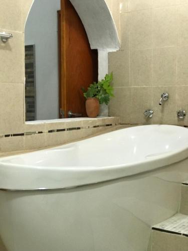 a white bath tub in a bathroom with a mirror at Real Carretero in Tapalpa