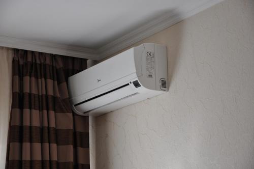 a microwave on the wall of a hotel room at Light House in Odesa