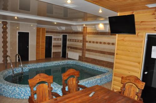 a large bath tub in a room with a tv at Light House in Odesa