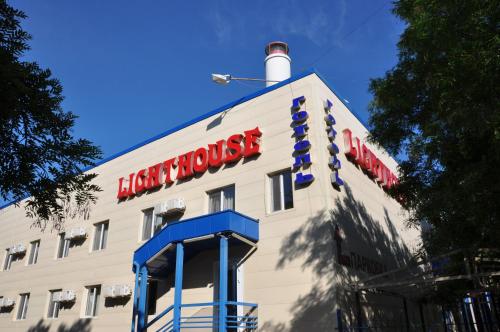 a hotel with a sign on the side of a building at Light House in Odesa