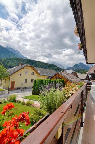 a view from the balcony of a house with flowers at Apartments and Rooms Banić in Kranjska Gora