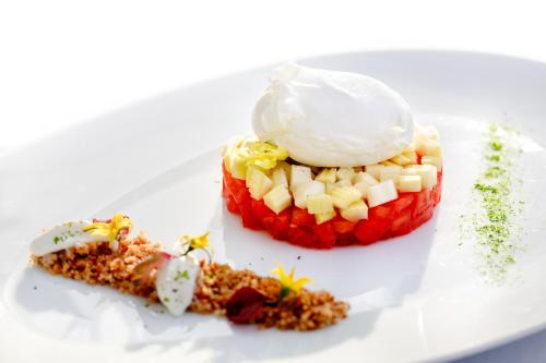 a white plate with a dessert with fruit on it at Hotel Torre Barbara in Vico Equense