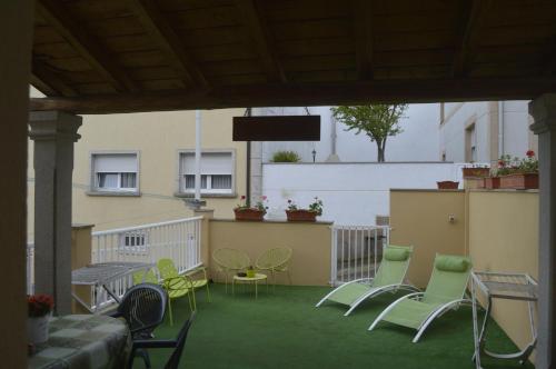 a group of chairs and tables on a balcony at Ultreia in Portomarin