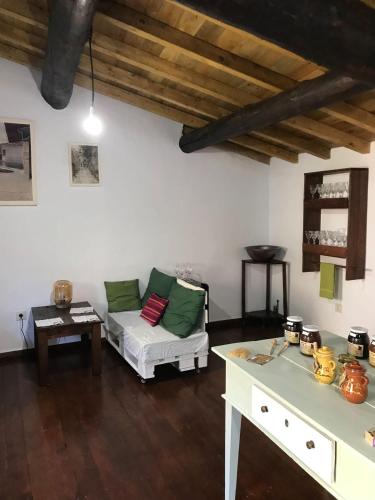 a living room with a couch and a table at Casa Rural Donatila in Villasbuenas de Gata