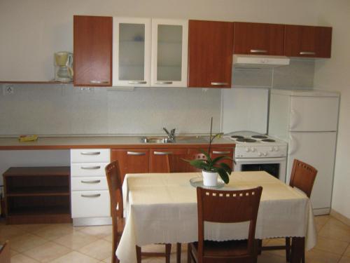 a kitchen with a table and a table and a table and chairs at Apartments Spert in Umag