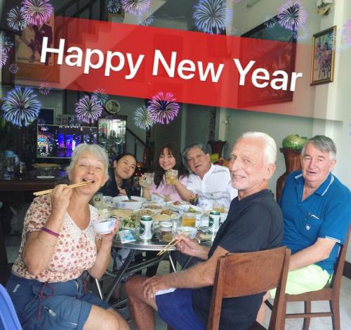 a group of people sitting around a table eating food at NGỌC QUÝ Mini House in Quy Nhon