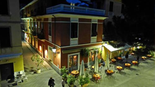 an overhead view of a building with tables and umbrellas at Albergo Lungomare in Bonassola