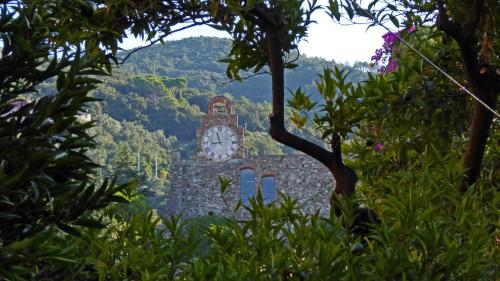 a building with a clock on the side of it at Albergo Lungomare in Bonassola