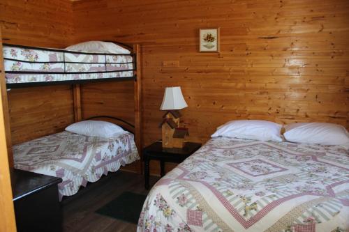 A bed or beds in a room at Chalets Grand Pre Cottages