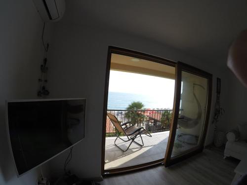 a mirror in a room with a view of a balcony at Loft Infinity in Petrovac na Moru