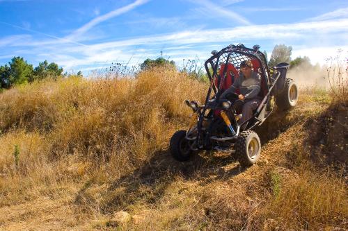 a person riding in a four wheeler in a field at Hotel Da Montanha in Pedrógão Pequeno