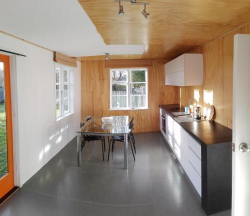 a kitchen with a table and a dining room at The Crawford's in Invercargill