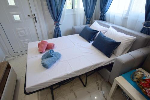 a white bed with two mitts sitting on it at V Luxury Suites Toroni 1 in Toroni