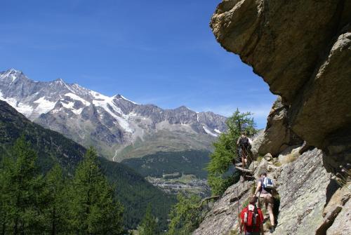 a group of people walking on a mountain trail at Appartement Flora in Saas-Almagell