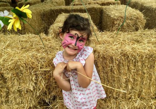a little girl with her face painted on at Agriturismo Monaci Templari in Seborga